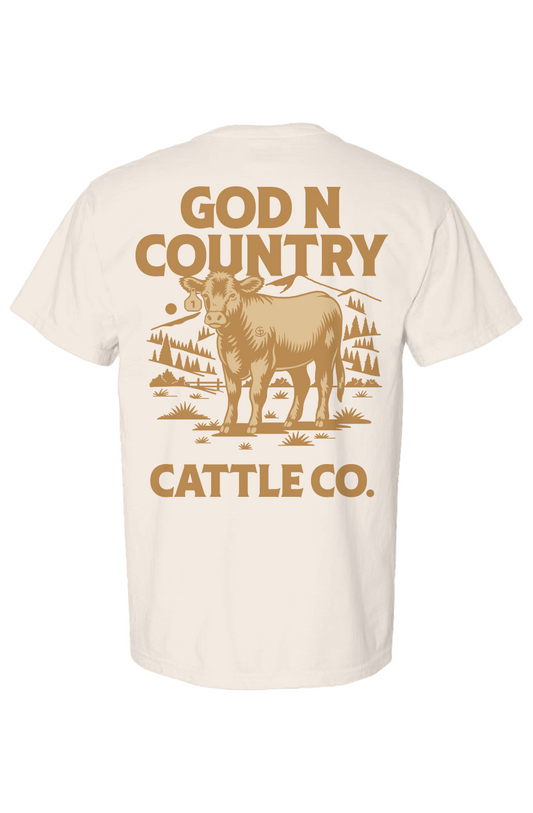 Beige t-shirt with 'God N Country Cattle Co.' text and cow graphic on a white background